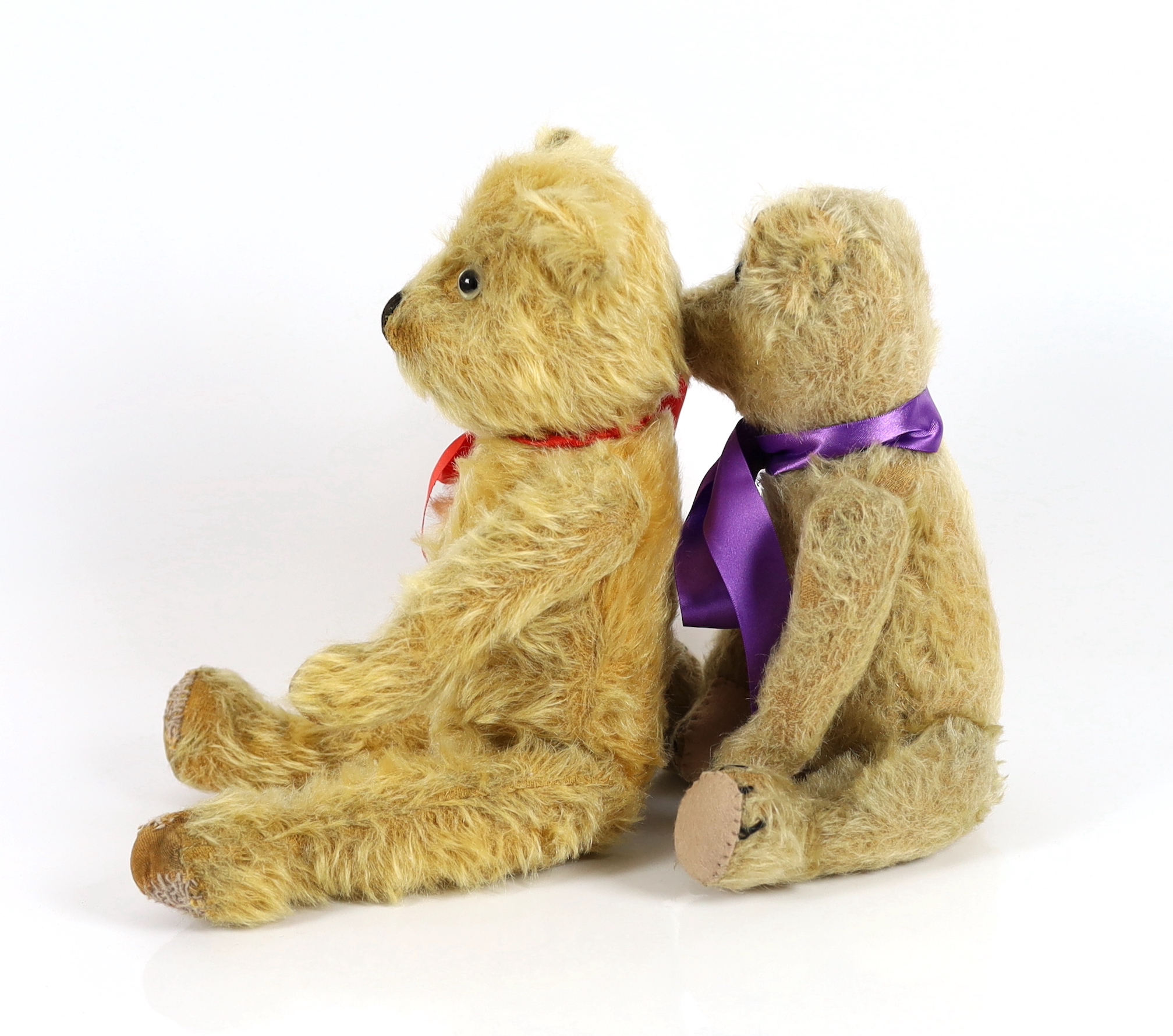 A plush covered bear with purple ribbon, 30cm and a plush covered bear with tartan ribbon, 36cm (2)